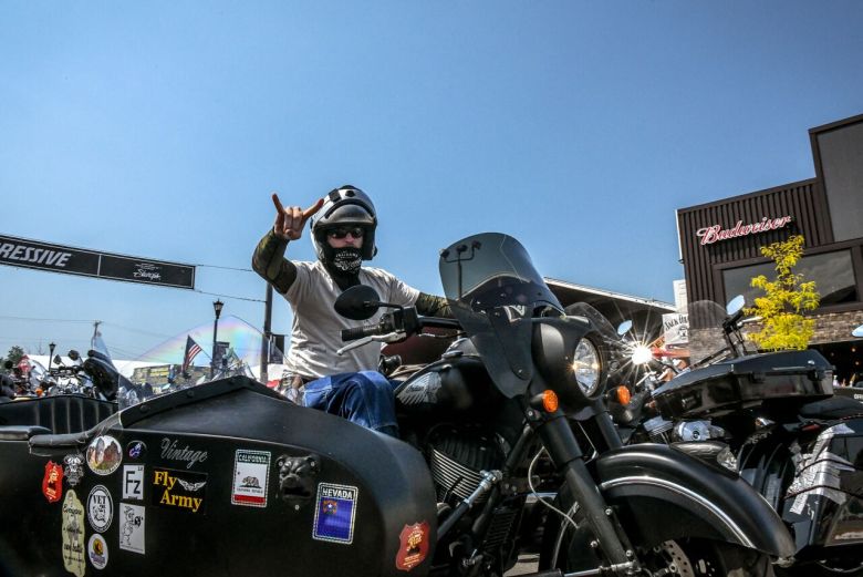 man with motorcycle sidecar sturgis rally.