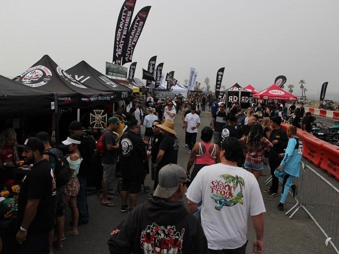 A crowd of people on the beach at a motorcycle event
