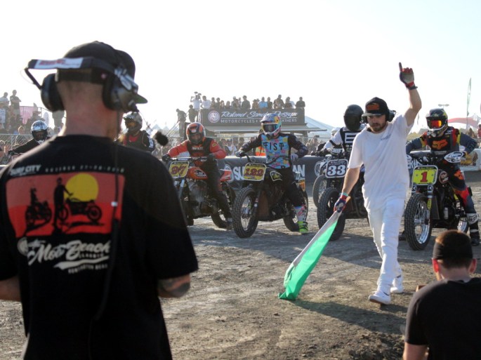 motorcycle flat track racers wait on the starting line of the moto beach classic surf city blitz