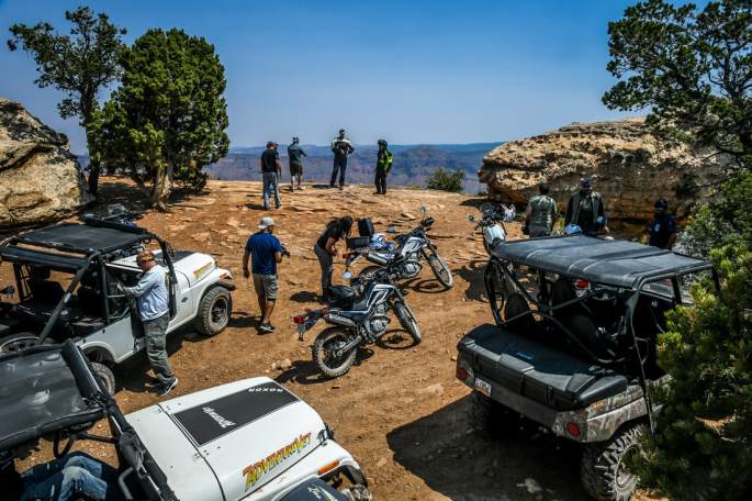 adventure veterans on a mountain lookout with motorcyles, UTV side by sides, and ROXOR off road vehicles.