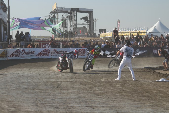 motorcycle flat tack racers sliding sideways across finish line