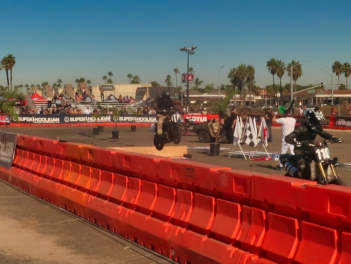 motorcycle jumping at a parking lot flat track race course