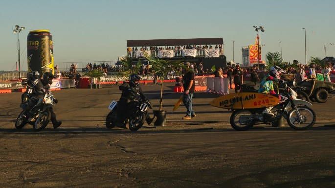 motorcycles racing flat track on asphalt