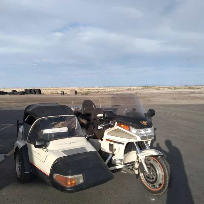 a honda motorcycle sidecar parked on a road