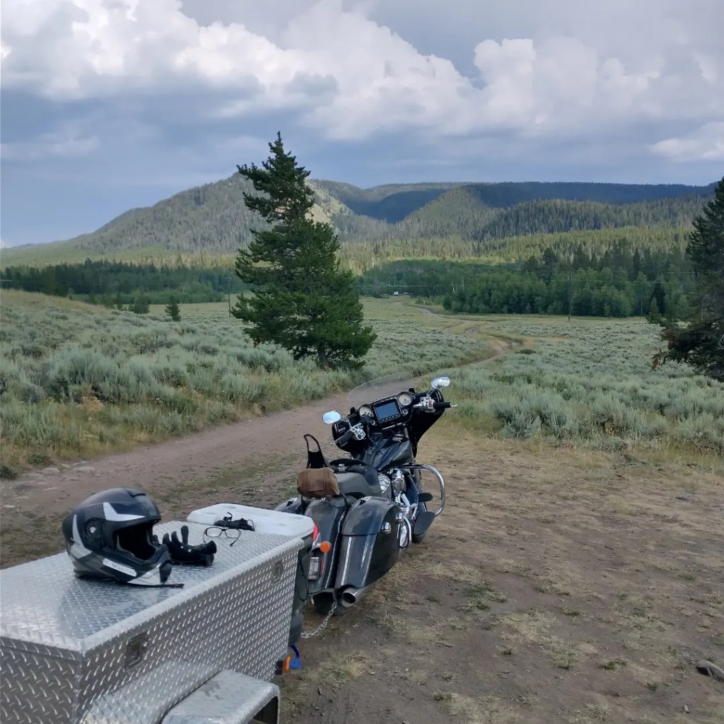 motorcycle and camping trailer in mountain forest