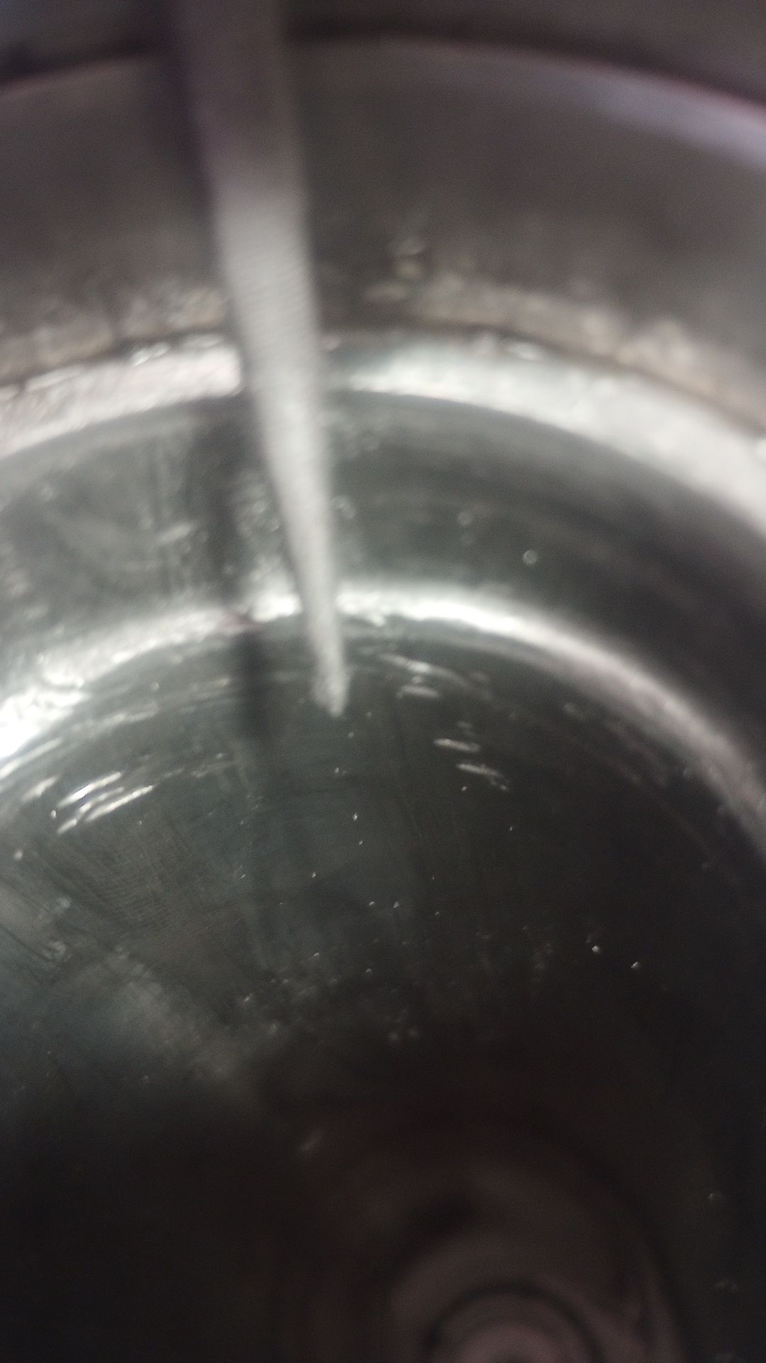 the inside of a motorcycle fork leg, damaged by scrathces and marring, being filed smooth with a small needle-file