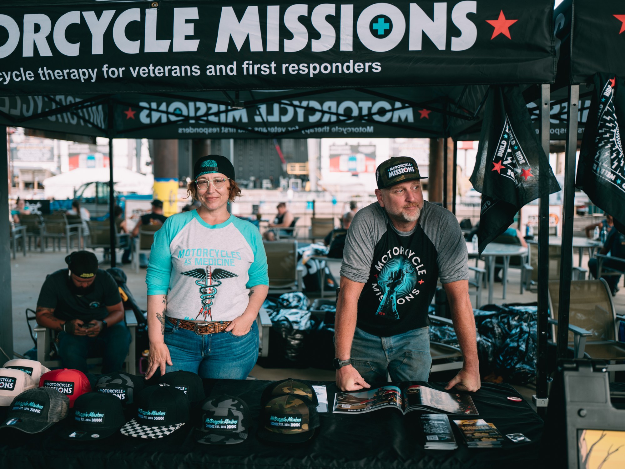 Motorcycle Missions booth at an event with two people ready to speak to people