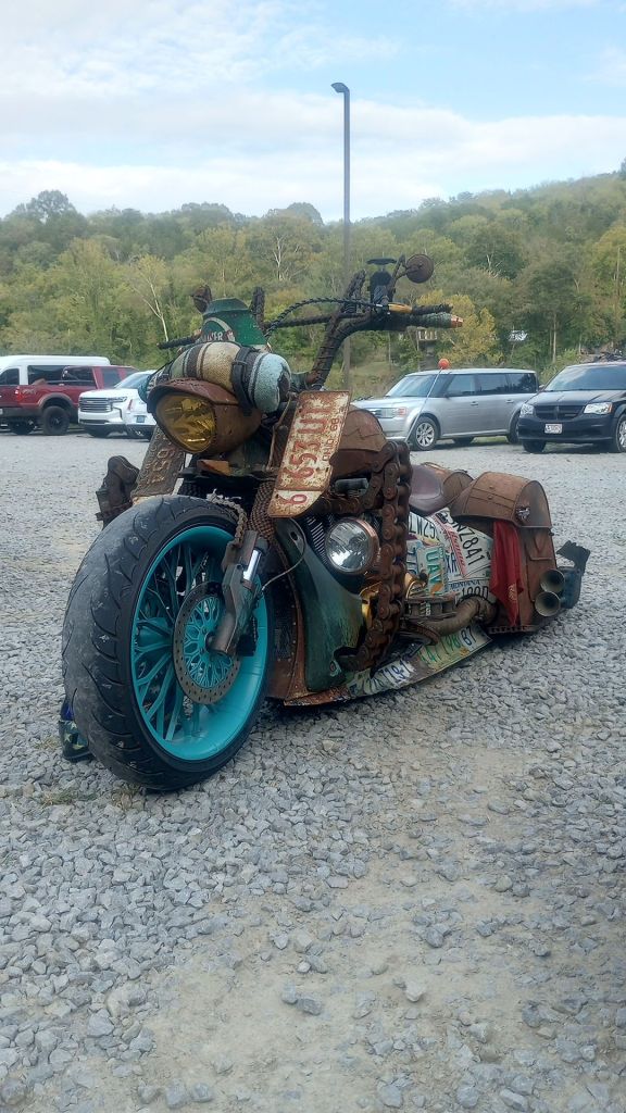 A custom chopper uses a modern engine and wheels while taking on an almost Mad Max vibe with rusty chains welded as crash guards and bent license plates as air deflectors