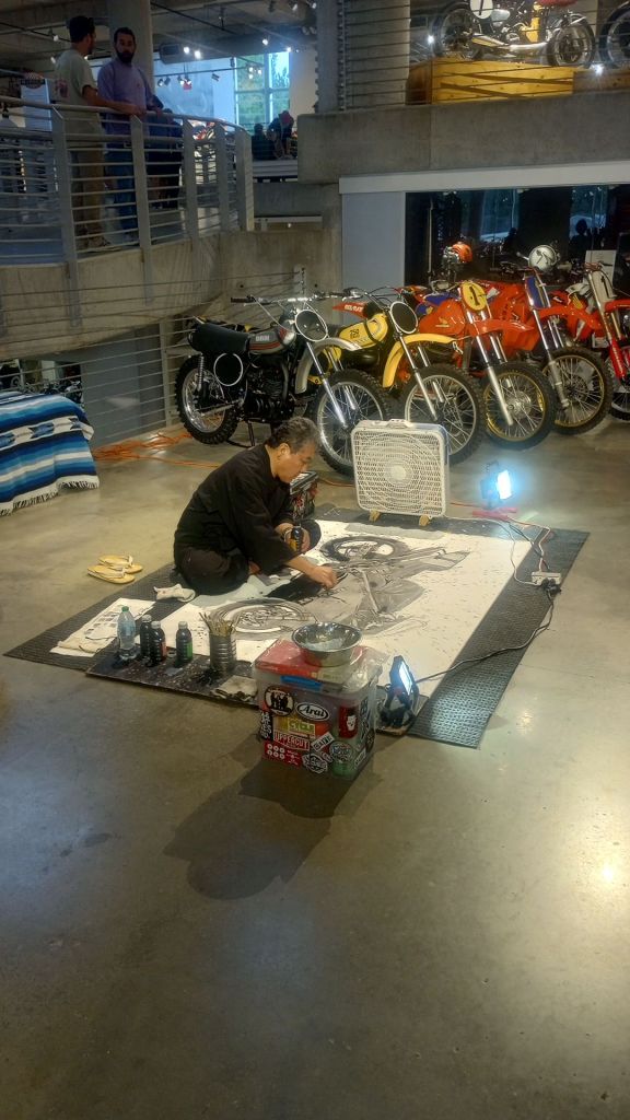 Artist painting a motorcycle in watercolor