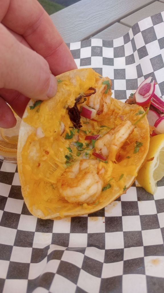 a Baja birria taco, with onion, cilantro, melted cheese and three large shrimp.
